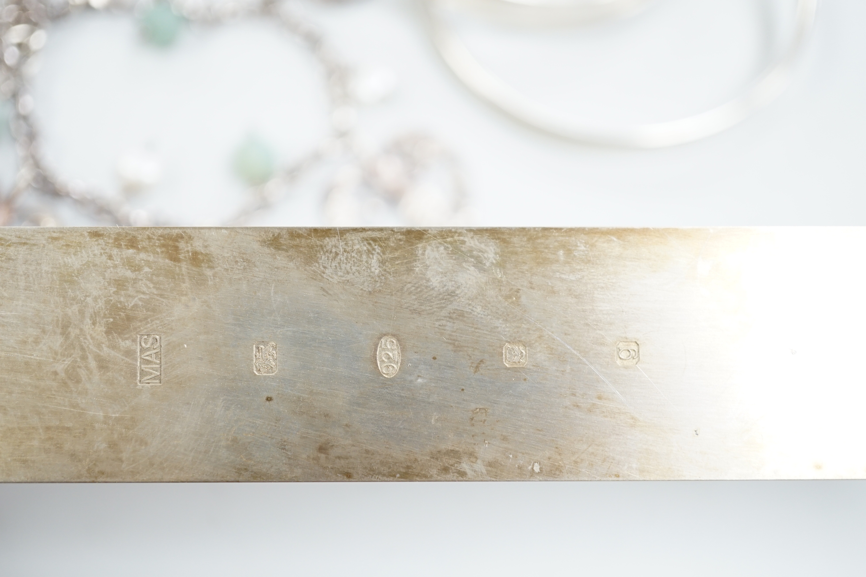 Three Pruden Smith bangles including triple loop, two other silver bangles, a white metal heart bracelet and one other bracelet, together with a straight edge rule by Mary Ann Simmons.